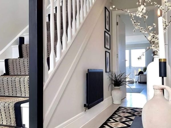 Freshly painted hallway and staircase with white trim and spindles