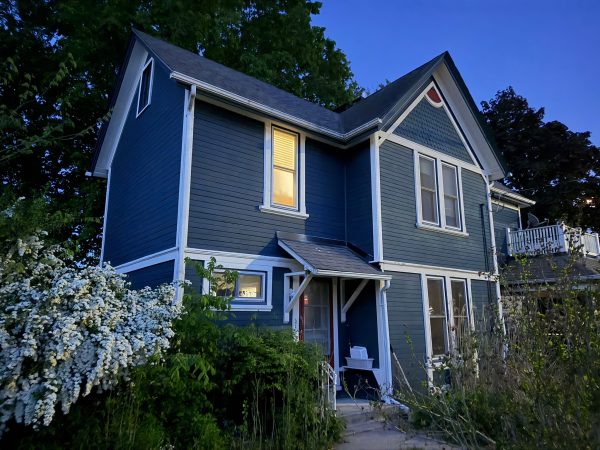 Two-storey house exterior painted blue with white trim